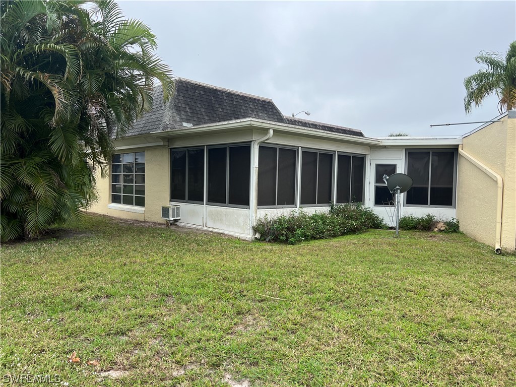 3 Regency Court Lehigh Acres, FL 33936 - Photo 6 of 27 a view of a house with backyard and garden