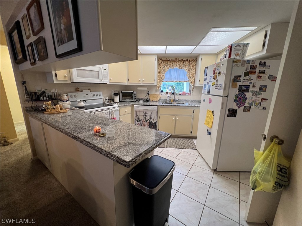 3 Regency Court Lehigh Acres, FL 33936 - Photo 10 of 27 a kitchen with granite countertop lots of counter top space