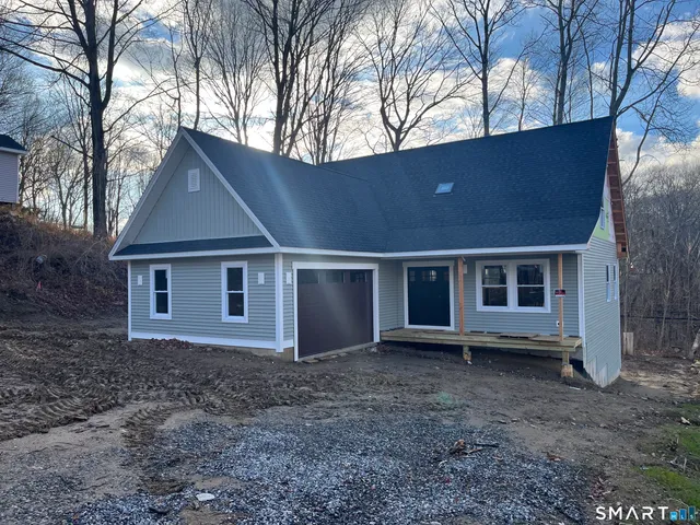 a house that has a tree in front of it