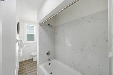 a bathroom with a bathtub and toilet