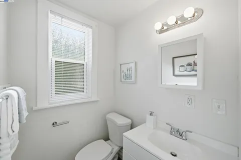 a bathroom with a toilet a sink and mirror