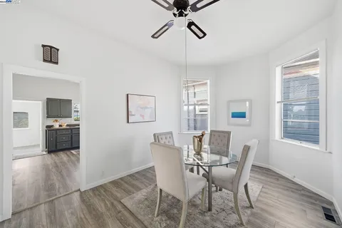 a view of a dining room with furniture and a window