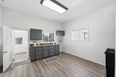 a kitchen with granite countertop a stove top oven and sink