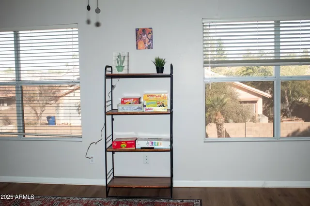 a room with window and painting on the wall