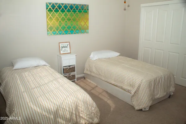 a bedroom with a bed and a wall painting