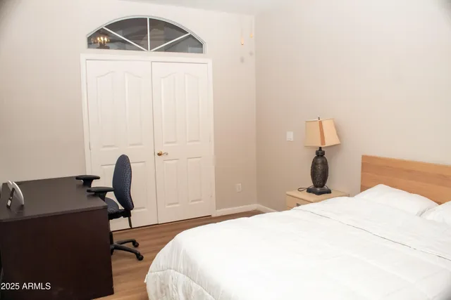 a bedroom with a bed and a desk