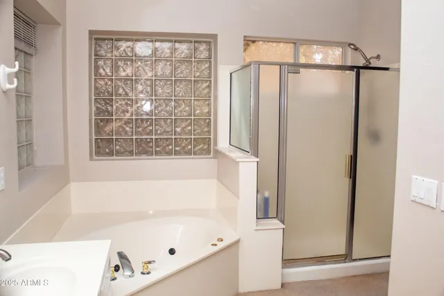 a bathroom with a bathtub and a shower