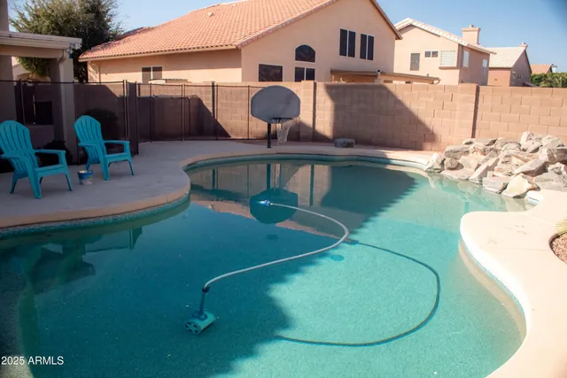 an aerial view of a house with pool table and chairs