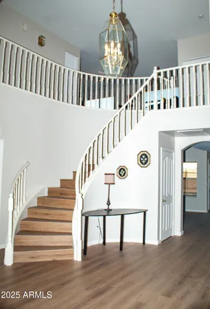 a view of entryway and hall with wooden floor