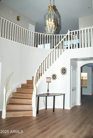 a view of entryway and hall with wooden floor