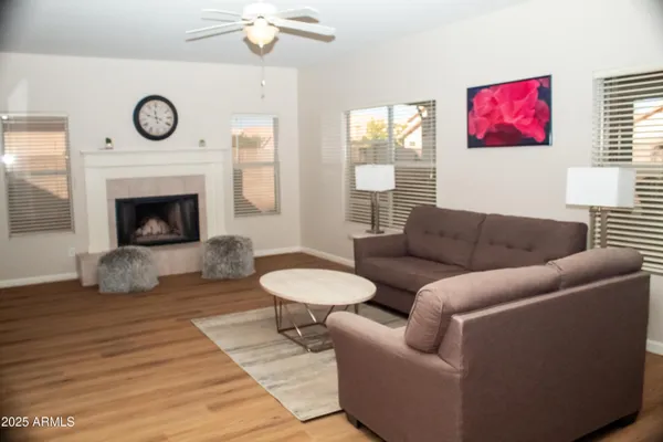 a living room with furniture a clock and a fireplace