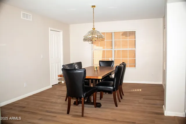 a dining room with furniture window and wooden floor