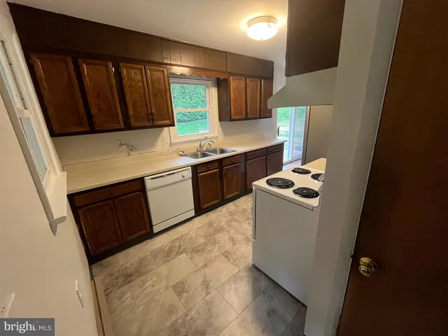 a kitchen with a stove top oven sink and cabinets