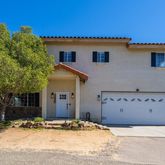 a view of a house with a snow in the background