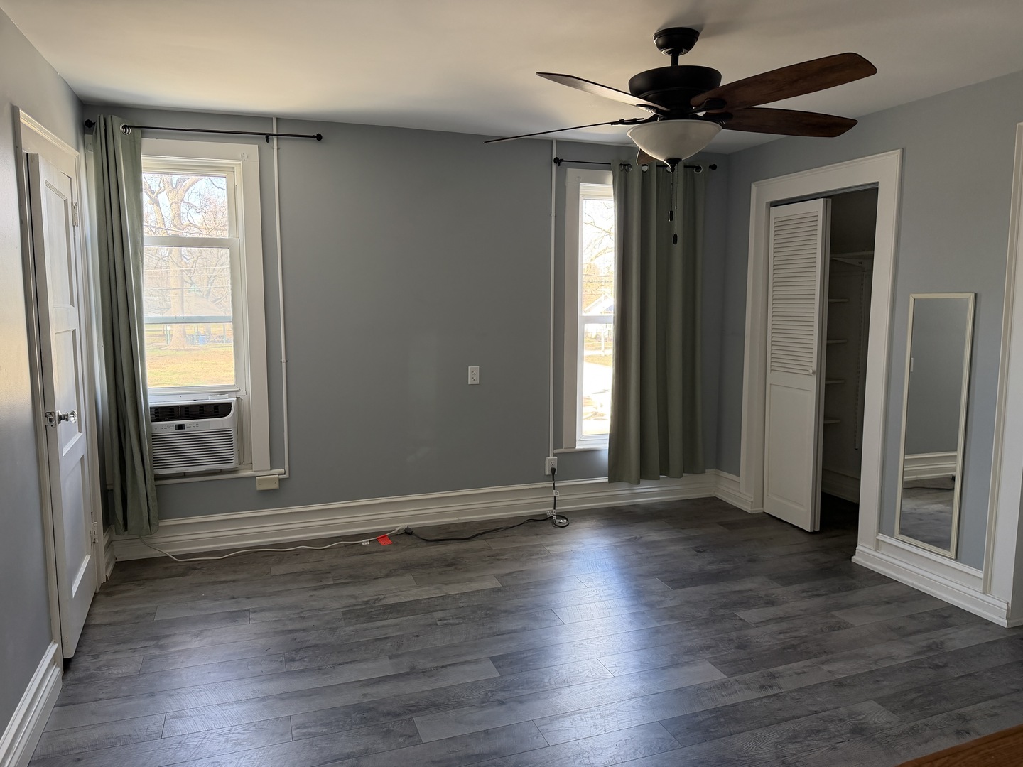 307 East Willow Street Normal, IL 61761 - Photo 3 of 10 an empty room with wooden floor fan and windows