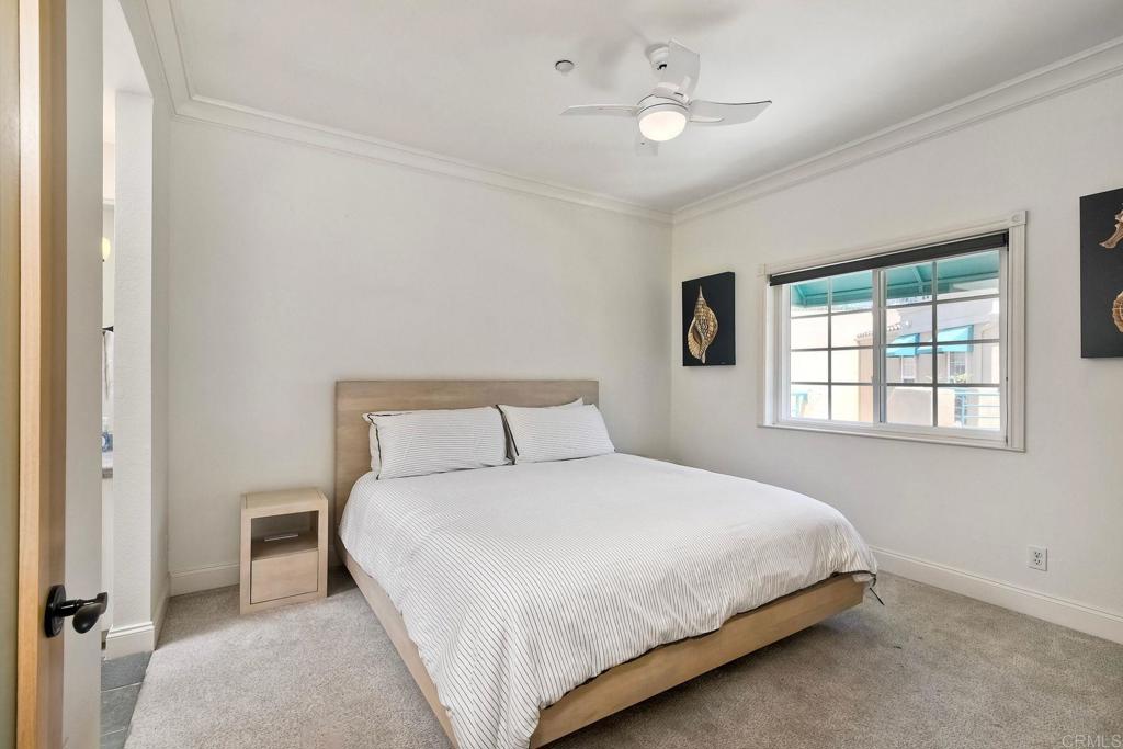400 The Strand North, Unit 46 Oceanside, CA 92054 - Photo 11 of 25 a bedroom with a bed and a window
