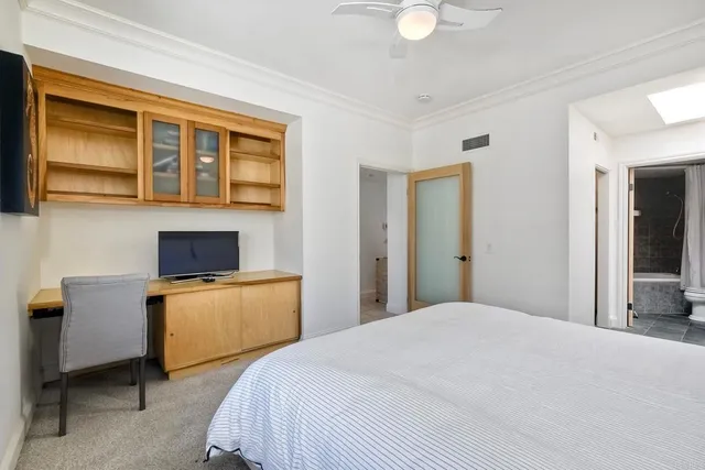 a bedroom with a bed and dresser