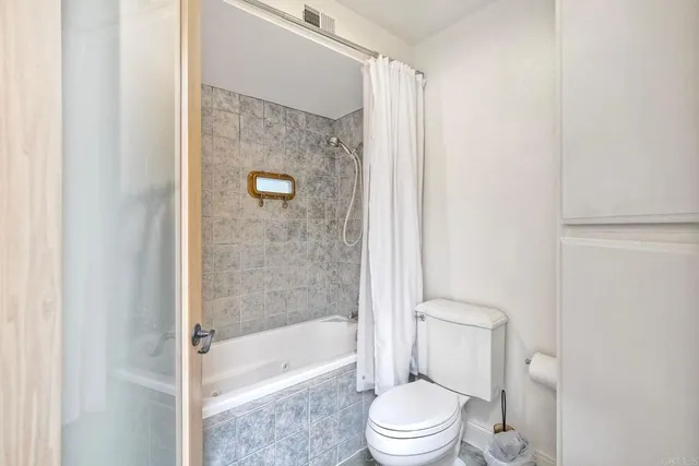 a bathroom with a toilet and shower