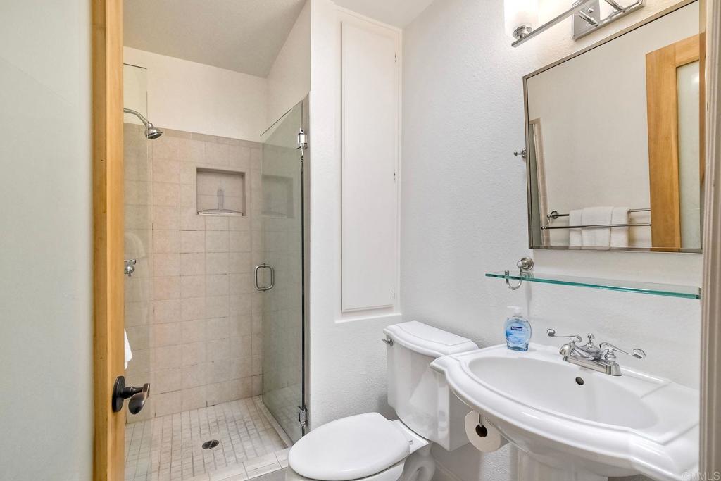400 The Strand North, Unit 46 Oceanside, CA 92054 - Photo 16 of 25 a bathroom with a sink toilet and shower
