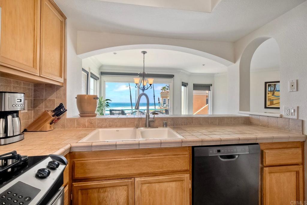400 The Strand North, Unit 46 Oceanside, CA 92054 - Photo 2 of 25 a kitchen with a sink and a refrigerator