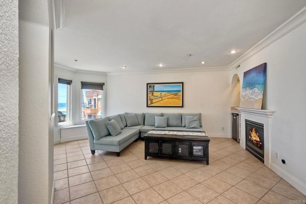 400 The Strand North, Unit 46 Oceanside, CA 92054 - Photo 4 of 25 a living room with furniture and a fireplace