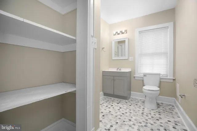 a bathroom with a sink a toilet and a shower