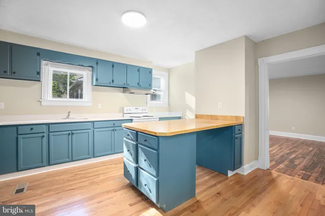 a kitchen with wooden cabinets and sink