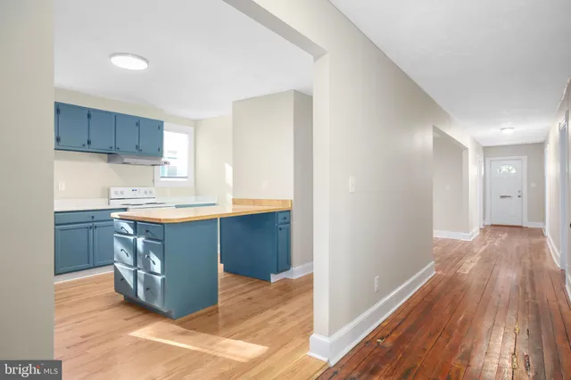 a kitchen with stainless steel appliances granite countertop a sink stove and wooden floor