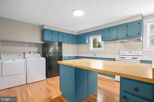 a utility room with sink washer and dryer