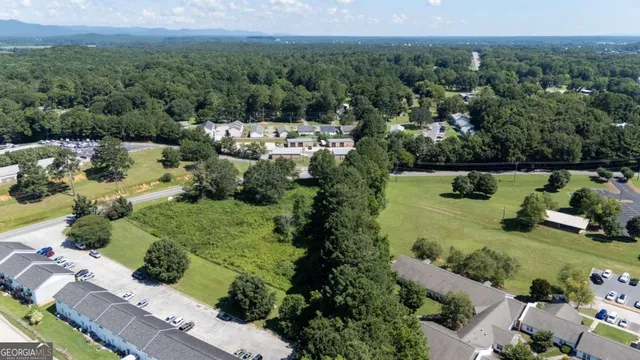 an aerial view of a house with a yard and lake view