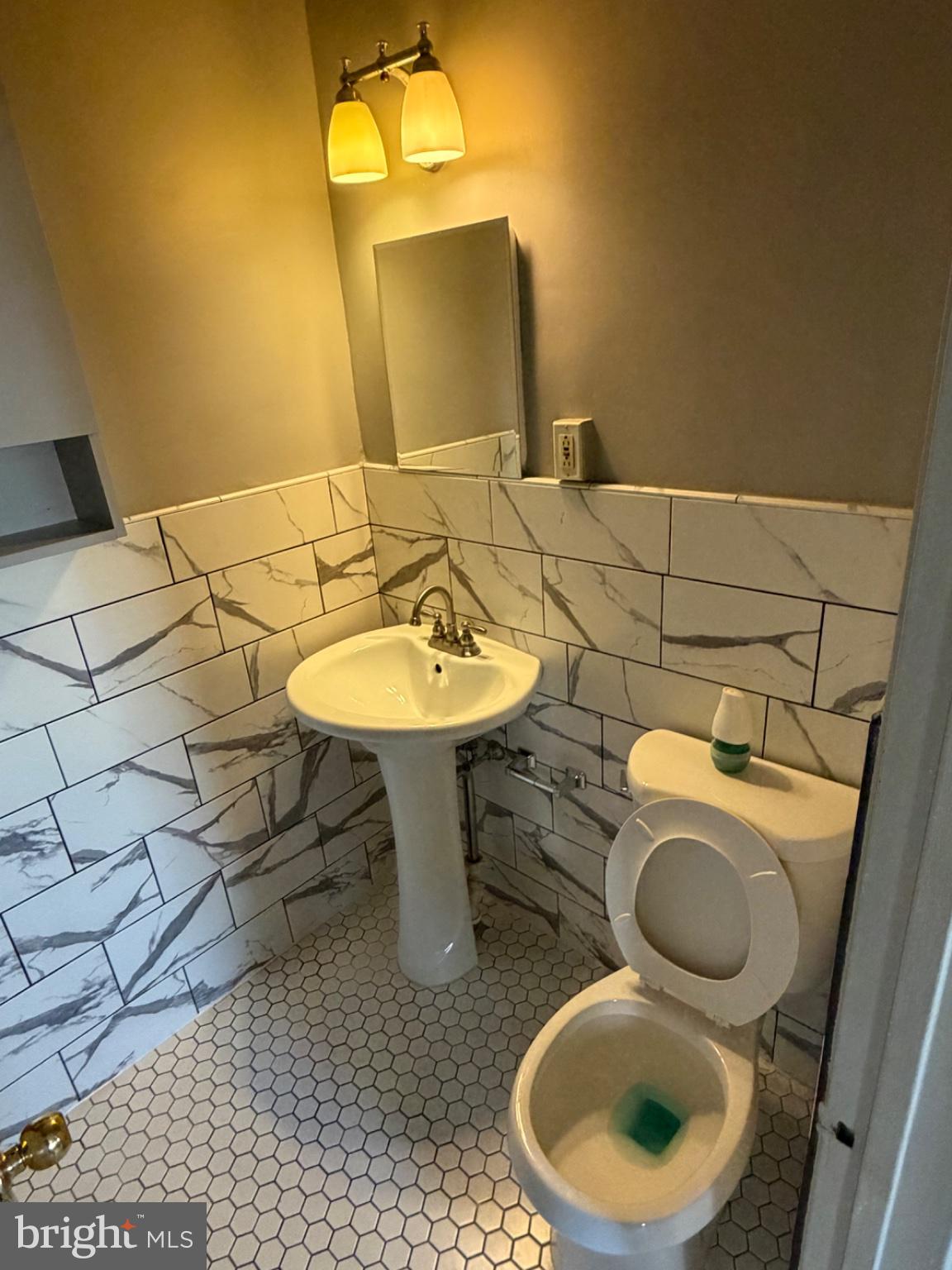 8300 Lynnewood Road Philadelphia, PA 19150 - Photo 6 of 11 Chic half-bath with modern tiles.