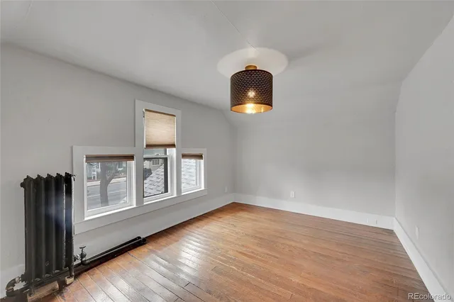 a view of a livingroom with wooden floor and a window