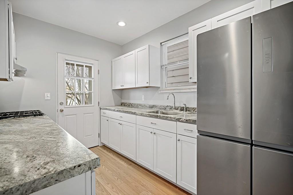 1167 Race Street McKees Rocks, PA 15136 - Photo 11 of 25 a kitchen with granite countertop a sink stove and refrigerator