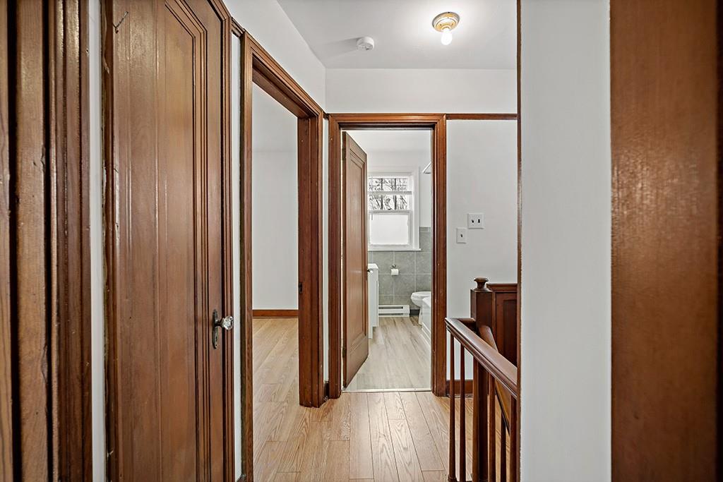 1167 Race Street McKees Rocks, PA 15136 - Photo 14 of 25 a view of a hallway with wooden floor and staircase