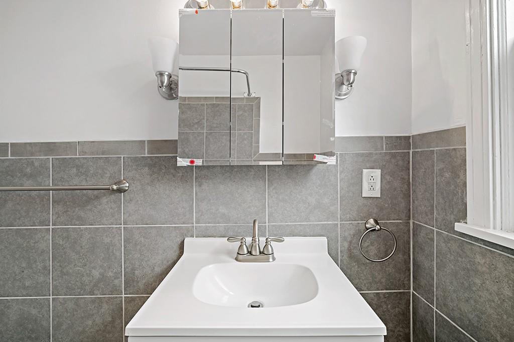 1167 Race Street McKees Rocks, PA 15136 - Photo 16 of 25 a bathroom with a sink a toilet and mirror