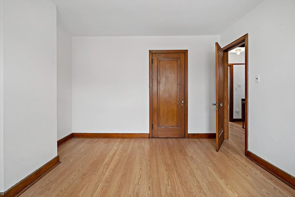 1167 Race Street McKees Rocks, PA 15136 - Photo 18 of 25 an empty room with wooden floor and closet