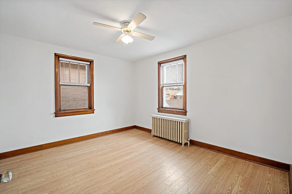 1167 Race Street McKees Rocks, PA 15136 - Photo 19 of 25 a view of an empty room with a window and wooden floor