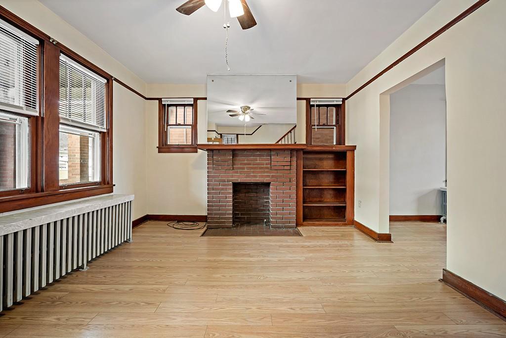 1167 Race Street McKees Rocks, PA 15136 - Photo 5 of 25 wooden floor fireplace and windows in an empty room