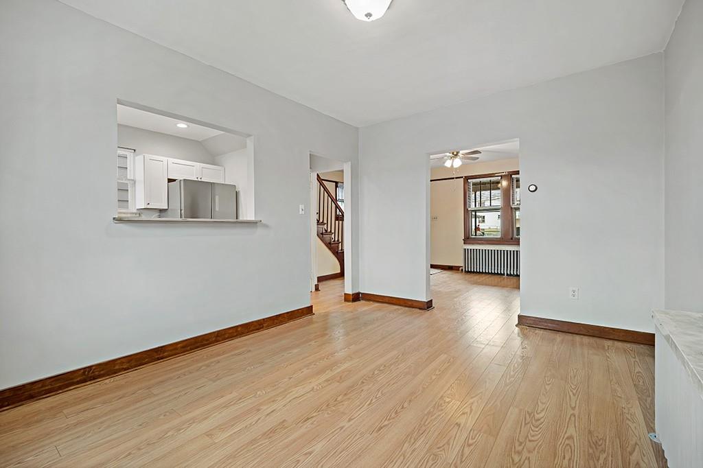 1167 Race Street McKees Rocks, PA 15136 - Photo 7 of 25 an empty room with wooden floor and windows