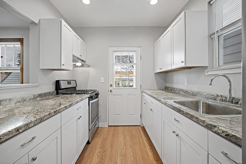 1167 Race Street McKees Rocks, PA 15136 - Photo 8 of 25 a kitchen with granite countertop a sink stove and cabinets