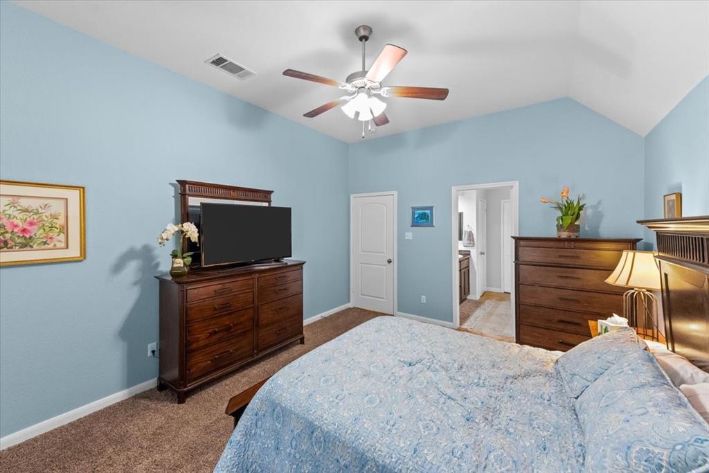 10861 Burnham Drive Waco, TX 76708 - Photo 13 of 27 a bedroom with a bed and a flat screen tv