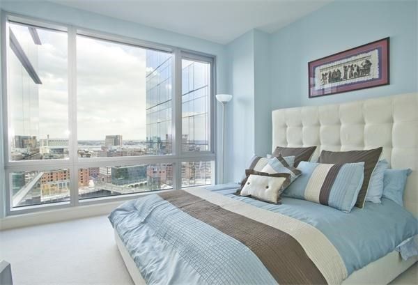 a bedroom with a large bed and a large window