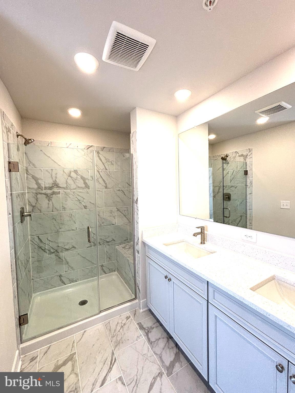 7700 Johnnycake Road Windsor Mill, MD 21244 - Photo 13 of 17 a bathroom with a shower sink and mirror