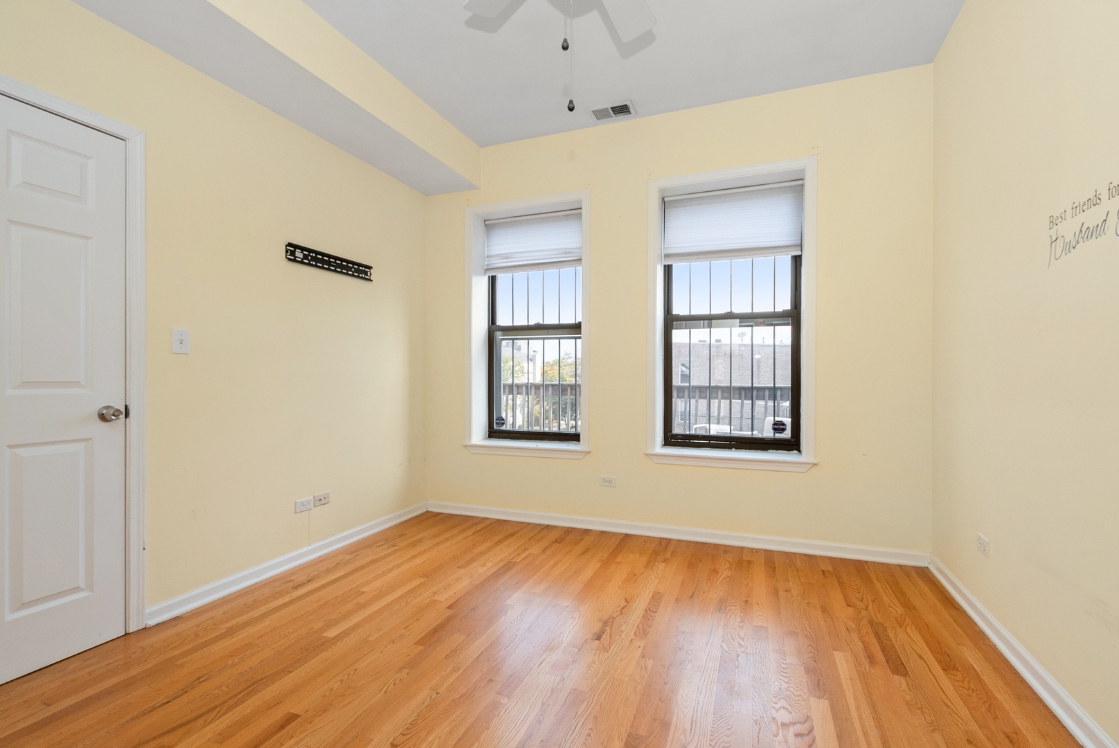 6603 South Kimbark Avenue, Unit 3 Chicago, IL 60637 - Photo 13 of 16 an empty room with wooden floor and windows