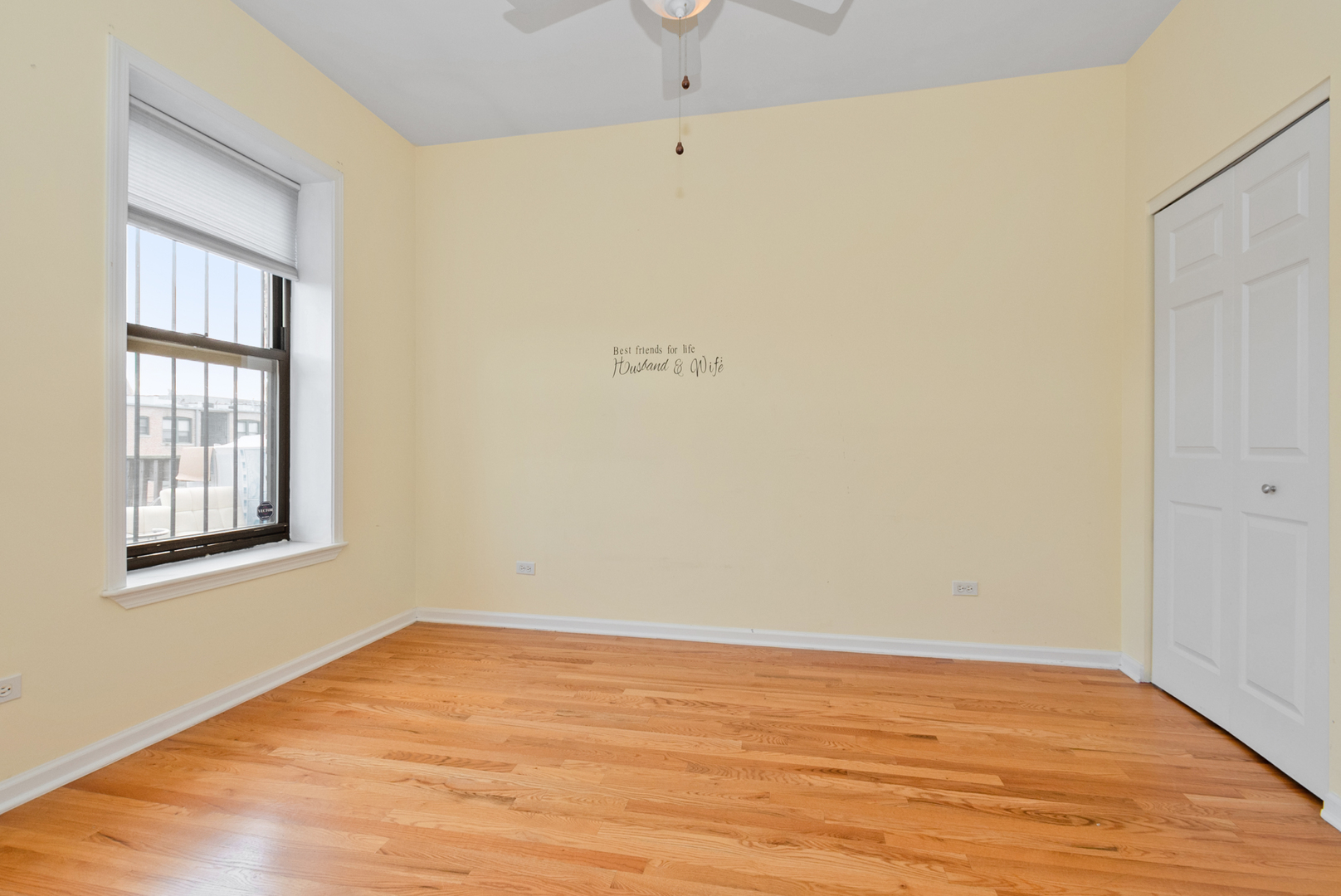 6603 South Kimbark Avenue, Unit 3 Chicago, IL 60637 - Photo 14 of 16 an empty room with wooden floor and windows