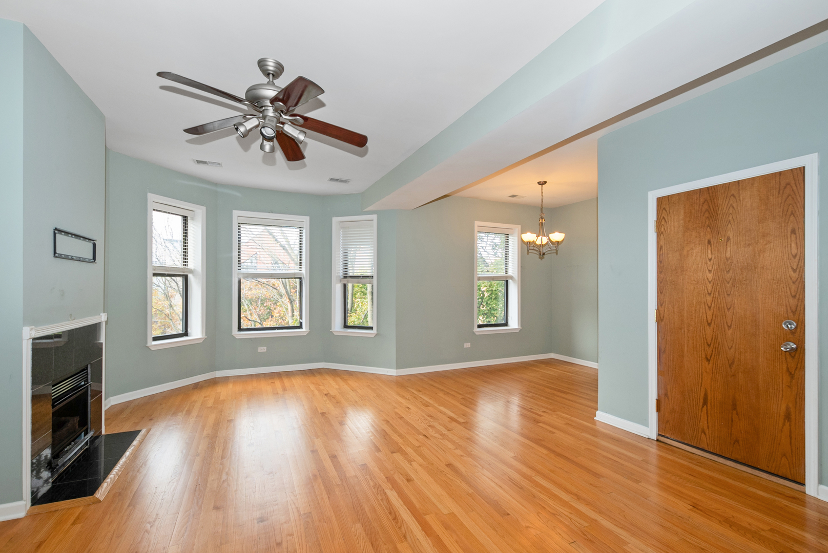 6603 South Kimbark Avenue, Unit 3 Chicago, IL 60637 - Photo 2 of 16 a view of an empty room with window and wooden floor