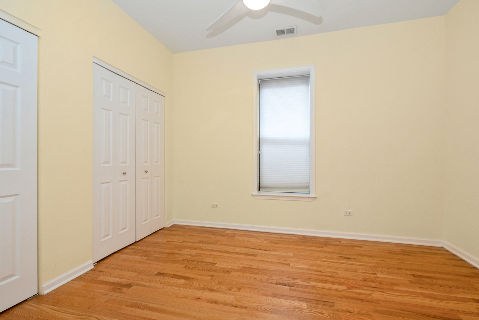 6603 South Kimbark Avenue, Unit 3 Chicago, IL 60637 - Photo 10 of 16 a view of an empty room with wooden floor and a window