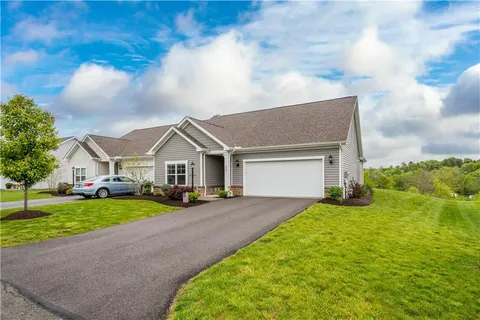 a view of a house with a yard and garage