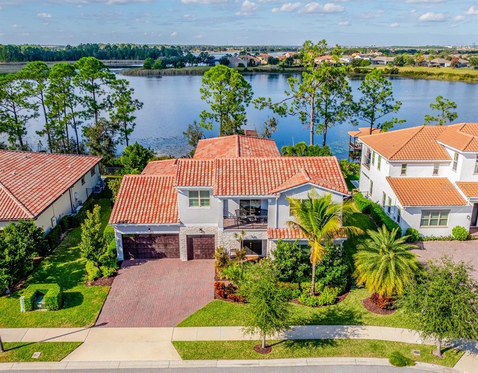 an aerial view of a house with a garden and lake view
