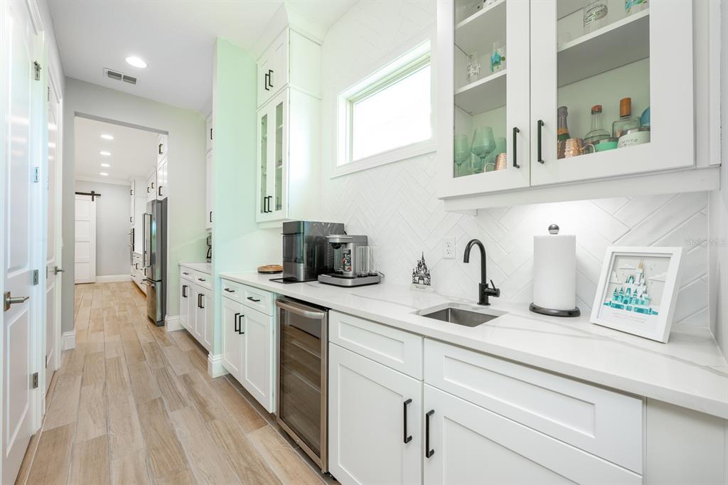 9014 Morgana Court Winter Garden, FL 34787 - Photo 16 of 55 a kitchen with kitchen island a sink appliances cabinets and a counter top space